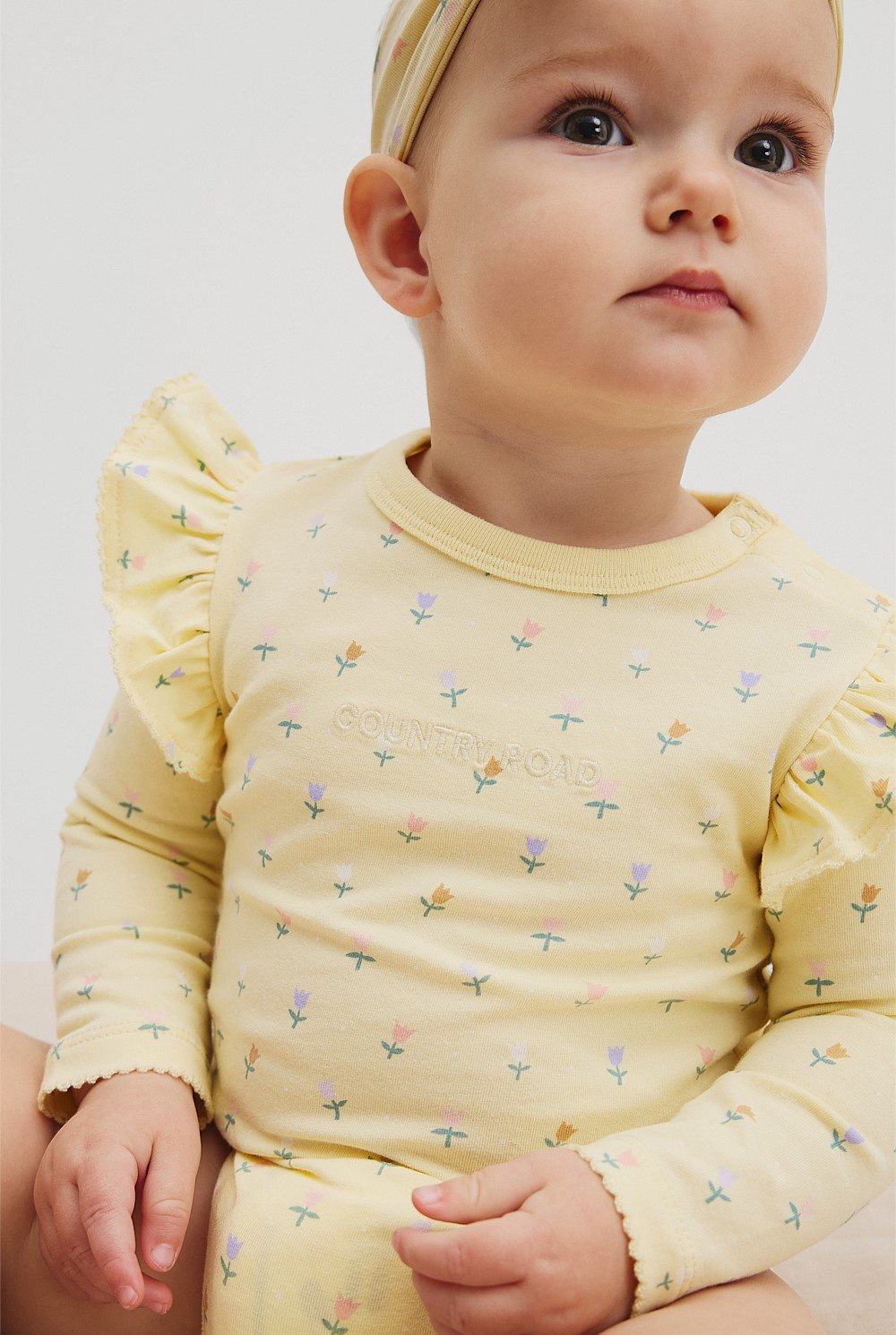 Organically Grown Cotton Frill Long Sleeve Logo Bodysuit